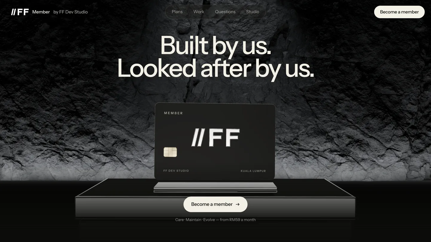 Built by us. Looked after by us. — the black member card on a chrome plinth against a lit rock wall